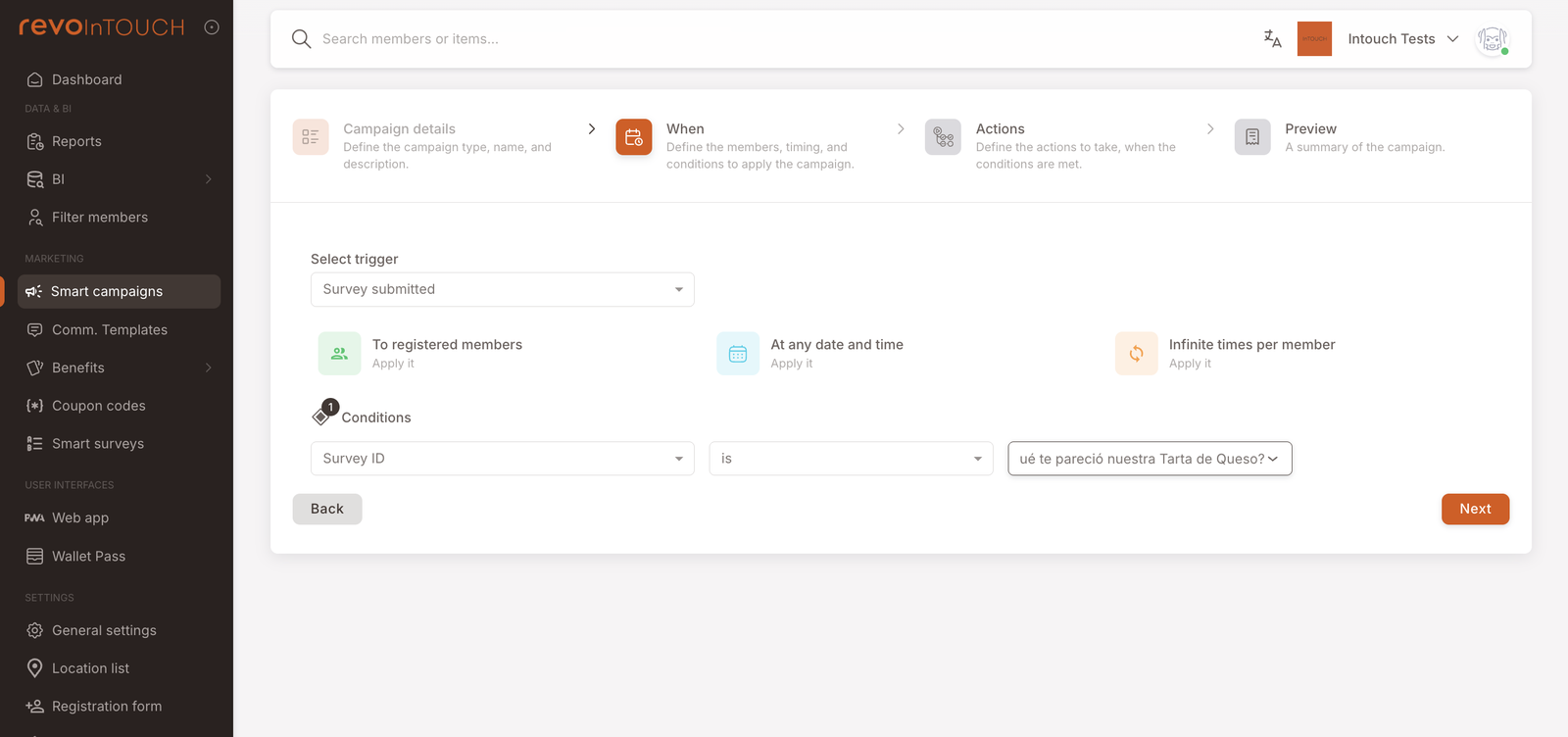 Smart Campaigns Step 2 — When. Trigger picker set to "Survey submitted". Three default tiles: To registered members, At any date and time, Infinite times per member. A Conditions row shows: Survey ID — is — "¿Qué te pareció nuestra Tarta de Queso?" (1).